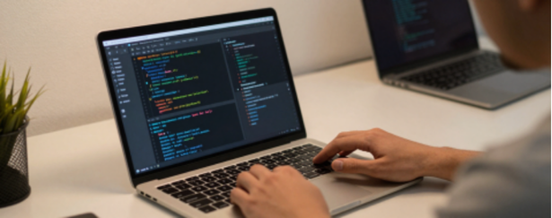 Software engineer writing code on a laptop